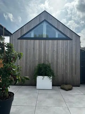 a wooden building with a large window on it at Pakhuis Prins in Zaandam