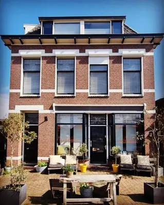 a brick building with a table in front of it at B&B Boskoop in Boskoop