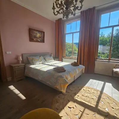 a bedroom with a bed and a large window at B&B Boskoop in Boskoop