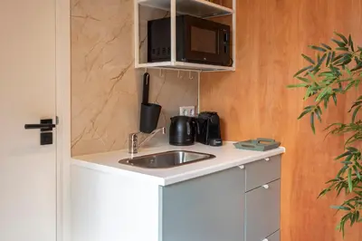 a kitchen with a sink and a microwave at Beachhouse Rina - Free Parking in Zandvoort