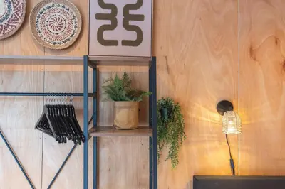 a shelf with plants and plates on a wall at Beachhouse Rina - Free Parking in Zandvoort