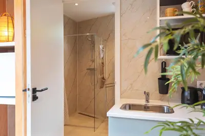 a bathroom with a sink and a shower at Beachhouse Rina - Free Parking in Zandvoort