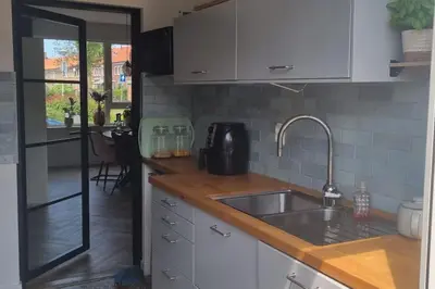 a kitchen with a sink and a counter top at Garden, Jacuzzi, bbq, city centre, 2 bedrooms in Alkmaar