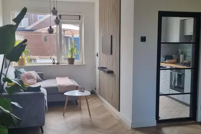 a living room with a couch and a table at Garden, Jacuzzi, bbq, city centre, 2 bedrooms in Alkmaar