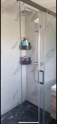 a shower with a glass door in a bathroom at Garden, Jacuzzi, bbq, city centre, 2 bedrooms in Alkmaar