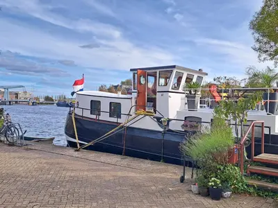 a blue and white boat docked on the water at B&B Teddy 