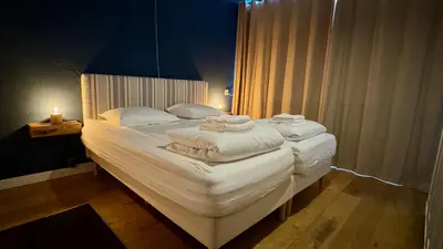 a bedroom with a bed with towels on it at Strand Panorama Egmond in Egmond aan Zee