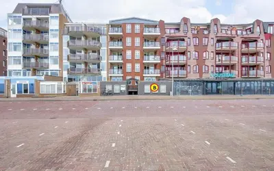 an empty parking lot in front of a large building at Studio B in Egmond aan Zee