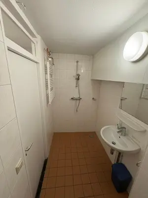 a bathroom with a shower and a sink at Studio B in Egmond aan Zee