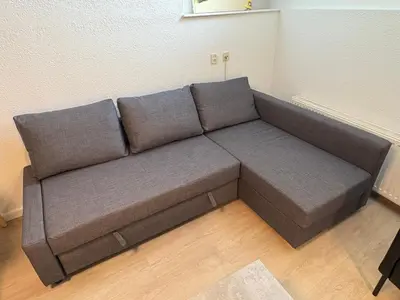 a brown couch in a room with at Studio B in Egmond aan Zee