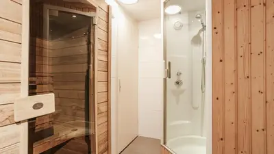 a bathroom with a shower and a glass door at Dutchen Park Weideduyn in Schoorl