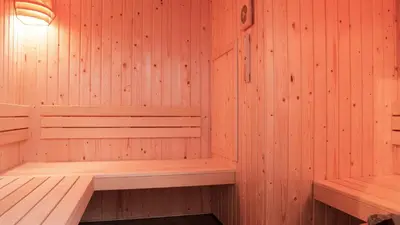 a wooden sauna with a wooden bench in it at Dutchen Park Weideduyn in Schoorl