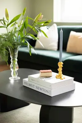 a table with two books and a candle on top at Villa Amsterdam Castle in Muiden