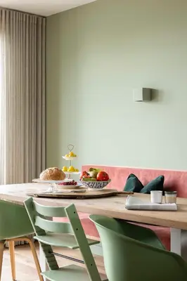 a dining room with a table with green chairs at Villa Amsterdam Castle in Muiden