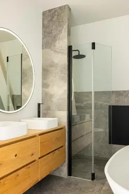 a bathroom with two sinks and a shower with a mirror at Villa Amsterdam Castle in Muiden