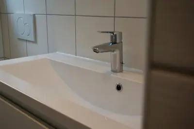 a sink with a faucet in a bathroom at B&B De groene loper in Sint Pancras