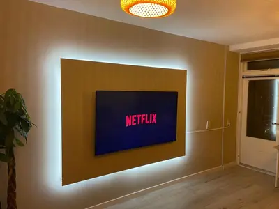 a television on a wall with a netflix sign on it at Beach Loft in Zandvoort