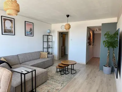 a living room with a couch and a table at Beach Loft in Zandvoort