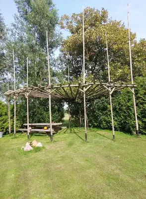 a wooden pavilion with a picnic table in a field at Back to Basic in Zwaanshoek