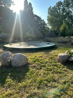 a small pool in the middle of a field with rocks at Back to Basic in Zwaanshoek