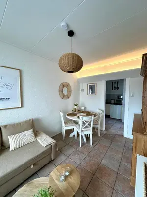 a living room with a couch and a table at Cosy Home Zandvoort in Zandvoort