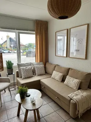 a living room with a couch and a table at Cosy Home Zandvoort in Zandvoort