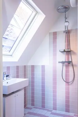 a bathroom with a sink and a shower with a skylight at Central Art Apartment - Nieuwmarkt area in Amsterdam