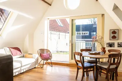 a living room with a table and a couch at Central Art Apartment - Nieuwmarkt area in Amsterdam