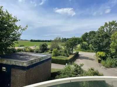 a view of a garden from the roof of a house at Burgervlotbrug aan zee met sauna in Burgerbrug