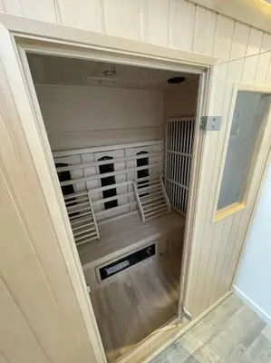 a room with a closet with a fan in it at Burgervlotbrug aan zee met sauna in Burgerbrug