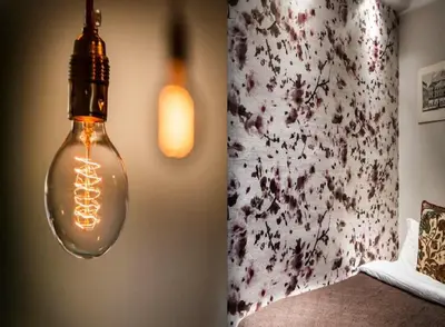 a light bulb hanging from a wall next to a bed at KeizersgrachtSuite471 in Amsterdam