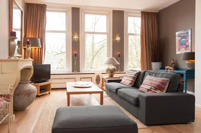 a living room with a couch and a tv at Livia's Hideaway Canalbelt in Amsterdam