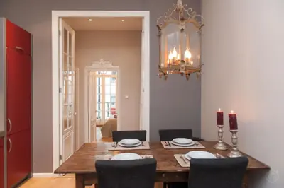 a dining room with a wooden table and chairs at Livia's Hideaway Canalbelt in Amsterdam