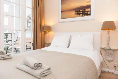 a bedroom with a white bed with towels on it at Livia's Hideaway Canalbelt in Amsterdam