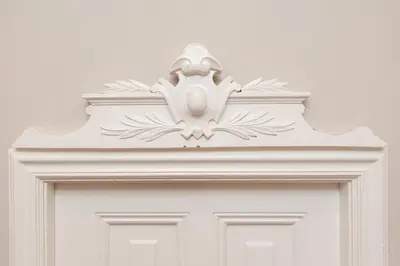 a white door with a carving on top of it at Livia's Hideaway Canalbelt in Amsterdam