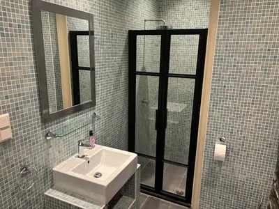a bathroom with a sink and a mirror at Livia's Hideaway Canalbelt in Amsterdam