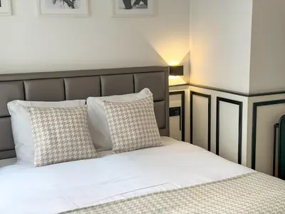 a bedroom with a bed with white sheets and pillows at Yourbnb Suites Haarlemmerstraat in Amsterdam