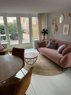 a living room with a couch and a table at Westerhuysje in Uitgeest