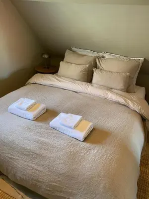 a bed with two towels on top of it at Guesthouse Porter Noordwijk in Noordwijk