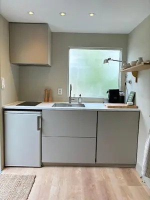 a kitchen with a sink and a window at Guesthouse Porter Noordwijk in Noordwijk