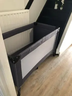 a small black and white bed in a room at Souterrain Sandy Sous in Noordwijk