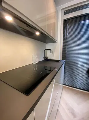 a kitchen with a black counter top and a window at Casa Wess in Zandvoort