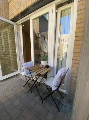 a patio with a table and chairs on a balcony at Casa Wess in Zandvoort