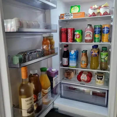 an open refrigerator filled with lots of food and drinks at Hermitage Suites & Apartments - Amsterdam Zaandam in Zaandam