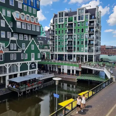 a group of buildings next to a river at Hermitage Suites & Apartments - Amsterdam Zaandam in Zaandam
