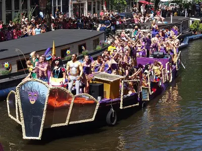 a large group of people riding on a boat in a parade at Hermitage Suites & Apartments - Amsterdam Zaandam in Zaandam
