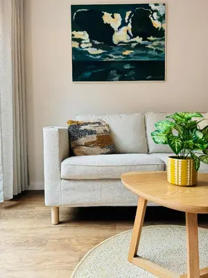 a living room with a couch and a table at Ocean Breeze - Noordwijk aan Zee in Noordwijk aan Zee