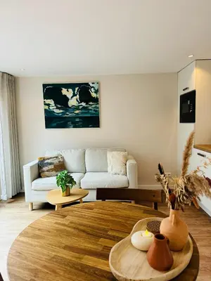 a living room with a couch and a table at Ocean Breeze - Noordwijk aan Zee in Noordwijk aan Zee