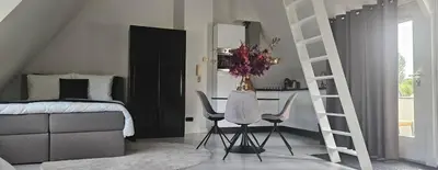 a bedroom with a bed and a table and chairs at Casa Roberto in Alkmaar