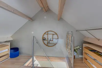 an attic room with a staircase and a mirror at 't Hutje centrum Uitgeest in Uitgeest